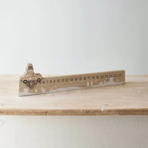 car Christmas countdown calendar rests on a wooden table