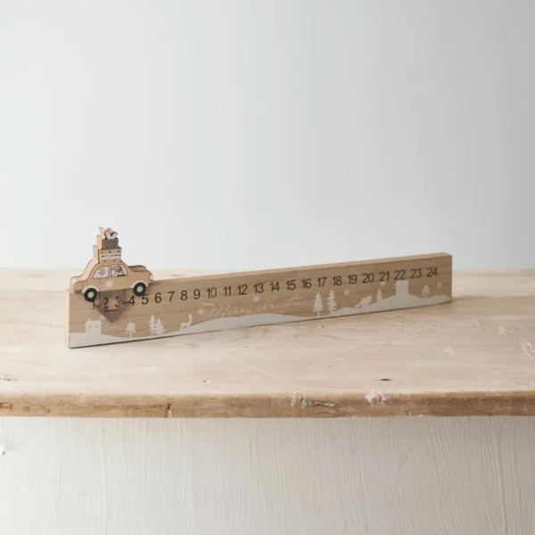 car Christmas countdown calendar rests on a wooden table